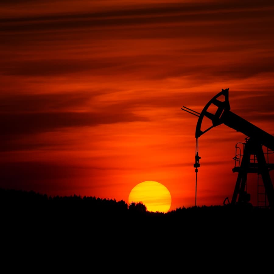 Pumpjack silhouetted against a sunset